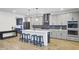 Bright kitchen featuring gray cabinets, a center island, and updated appliances at 203 Plowden Mill Ct, Summerville, SC 29485