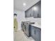 The laundry room showcases modern appliances and ample cabinet space for storage at 203 Plowden Mill Ct, Summerville, SC 29485