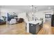 Open-concept kitchen, stairs, and living room with a fireplace and stylish decor at 203 Plowden Mill Ct, Summerville, SC 29485