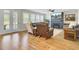 Spacious living room featuring hardwood floors, a fireplace, and lots of windows at 203 Plowden Mill Ct, Summerville, SC 29485