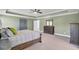 The main bedroom is spacious and well-lit, offering a peaceful retreat with classic furnishings and serene ambiance at 203 Plowden Mill Ct, Summerville, SC 29485