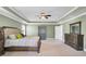 Relaxing main bedroom with tray ceiling, comfy bed, and natural light, creating a serene retreat at 203 Plowden Mill Ct, Summerville, SC 29485