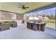 Enjoy this screened-in porch with wicker seating and a table for outdoor dining and relaxation at 203 Plowden Mill Ct, Summerville, SC 29485