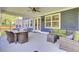 Relax on the screened-in porch with comfortable seating, a dining table, and a view of the yard at 203 Plowden Mill Ct, Summerville, SC 29485