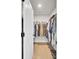 Well-lit walk-in closet with organized hanging space and shoe racks, offering efficient storage solutions at 203 Plowden Mill Ct, Summerville, SC 29485