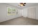 Carpeted bedroom features a ceiling fan, window, and closet at 204 Runnymede Ln, Summerville, SC 29485