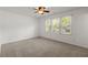 Carpeted bedroom features a ceiling fan and sun-filled windows at 204 Runnymede Ln, Summerville, SC 29485