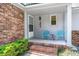 Cozy front porch with seating, perfect for relaxing, with brick accents at 204 Runnymede Ln, Summerville, SC 29485