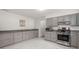 Well-lit kitchen with ample gray cabinets, sleek countertops, and stainless steel appliances for a modern cooking experience at 204 Runnymede Ln, Summerville, SC 29485
