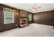 Inviting living room with wood paneling, a brick fireplace, and natural light streaming through the windows at 204 Runnymede Ln, Summerville, SC 29485