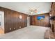 Bright living room with wood paneling, a brick fireplace, and a TV, offering a cozy and inviting atmosphere at 204 Runnymede Ln, Summerville, SC 29485