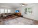 Open-concept living room with a ceiling fan, hardwood flooring, and natural light at 204 Runnymede Ln, Summerville, SC 29485