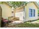 Cozy backyard patio area with seating surrounded by lush greenery and a yellow house at 210 Allen Richard Ct # A&B, Moncks Corner, SC 29461
