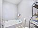 Bathroom with white bathtub, toilet, gray walls, and black metal shelving at 210 Allen Richard Ct # A&B, Moncks Corner, SC 29461