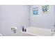 Bright bathroom with a clean white tub and walls with colorful art at 210 Allen Richard Ct # A&B, Moncks Corner, SC 29461