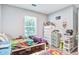 Bright bedroom with colorful decor, hardwood floors, and a large window at 210 Allen Richard Ct # A&B, Moncks Corner, SC 29461