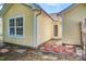Side view of the home featuring yellow siding, white trim, and a small back patio at 210 Allen Richard Ct # A&B, Moncks Corner, SC 29461