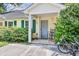 Charming front porch with green shutters, a gray front door, and seating area at 210 Allen Richard Ct # A&B, Moncks Corner, SC 29461