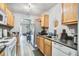 Functional kitchen with wood cabinets, stainless steel refrigerator, and an open view to the living room at 210 Allen Richard Ct # A&B, Moncks Corner, SC 29461