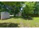 Green back yard with a utility shed, ideal for storage or hobbies at 210 Froman Dr, Summerville, SC 29483
