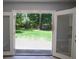 French doors open to a lush, green backyard with mature trees and a patio at 210 Froman Dr, Summerville, SC 29483