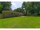 The large backyard features mature trees, well-maintained lawn, and a private patio at 210 Froman Dr, Summerville, SC 29483