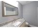 Bathroom with granite countertop sink, modern mirror, and white tile in the shower at 210 Froman Dr, Summerville, SC 29483