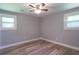 Neutral bedroom features new floors, two windows allowing ample light, and baseboard trim at 210 Froman Dr, Summerville, SC 29483
