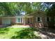 Quaint brick home with a well-maintained lawn, bright white shutters, and a welcoming front porch at 210 Froman Dr, Summerville, SC 29483