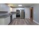 Remodeled kitchen with stainless appliances, granite counters, white cabinets and hardwood-style floors at 210 Froman Dr, Summerville, SC 29483