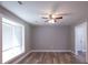 Bright, open living room with new floors, ceiling fan, and ample natural light from the large window at 210 Froman Dr, Summerville, SC 29483