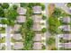 An aerial view showcases a residential neighborhood featuring well-manicured lawns and mature trees at 2242 Dewees Creek Dr, Mount Pleasant, SC 29466