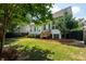 A beautifully landscaped backyard featuring a well-maintained lawn, trees, and wood deck at 2242 Dewees Creek Dr, Mount Pleasant, SC 29466