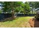 A spacious backyard is enclosed by a dark privacy fence and shaded by mature trees at 2242 Dewees Creek Dr, Mount Pleasant, SC 29466