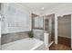 Bathroom showcasing soaking tub, glass-enclosed shower, and tiled walls at 2242 Dewees Creek Dr, Mount Pleasant, SC 29466