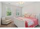 Bright bedroom offers a comfortable chair and windows, creating a cozy and inviting space at 2242 Dewees Creek Dr, Mount Pleasant, SC 29466