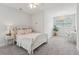Cozy bedroom features neutral decor, plush carpeting, and a comfortable bed with soft pillows at 2242 Dewees Creek Dr, Mount Pleasant, SC 29466