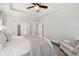 Bright bedroom featuring tray ceiling, ceiling fan, and neutral color palette at 2242 Dewees Creek Dr, Mount Pleasant, SC 29466