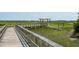 A picturesque boardwalk leading to a waterfront gazebo overlooking the marsh and waterway at 2242 Dewees Creek Dr, Mount Pleasant, SC 29466