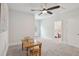 Upstairs bonus room with neutral carpet and ceiling fan with view to bedroom at 2242 Dewees Creek Dr, Mount Pleasant, SC 29466
