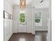 Bright entryway with dark wood floors, white wainscoting, and a decorative chandelier creating a welcoming ambiance at 2242 Dewees Creek Dr, Mount Pleasant, SC 29466