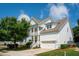 Charming two-story home with a white exterior, a two-car garage, and well-manicured landscaping at 2242 Dewees Creek Dr, Mount Pleasant, SC 29466