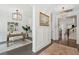 Elegant hallway showcasing dark wood floors, neutral walls, and a view into an office space with stylish decor at 2242 Dewees Creek Dr, Mount Pleasant, SC 29466