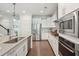 Modern kitchen featuring stainless steel appliances, white cabinets, granite countertops, and a stylish design at 2242 Dewees Creek Dr, Mount Pleasant, SC 29466