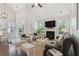 Inviting living room featuring a fireplace, large windows, and stylish decor at 2242 Dewees Creek Dr, Mount Pleasant, SC 29466