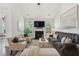 Elegant living room with a fireplace, comfortable seating, and ample natural light at 2242 Dewees Creek Dr, Mount Pleasant, SC 29466