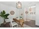 Comfortable office with a rustic wooden desk, an elegant white chair, and stylish contemporary decor and lighting at 2242 Dewees Creek Dr, Mount Pleasant, SC 29466