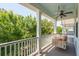 Relaxing front porch with swing, ceiling fan, and view of lush greenery at 2242 Dewees Creek Dr, Mount Pleasant, SC 29466
