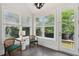Cozy sunroom bathed in natural light, featuring views of the lush backyard at 2242 Dewees Creek Dr, Mount Pleasant, SC 29466