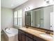 Bathroom featuring a double vanity, soaking tub, and granite countertop at 225 Slipper Shell Ct, Mount Pleasant, SC 29464